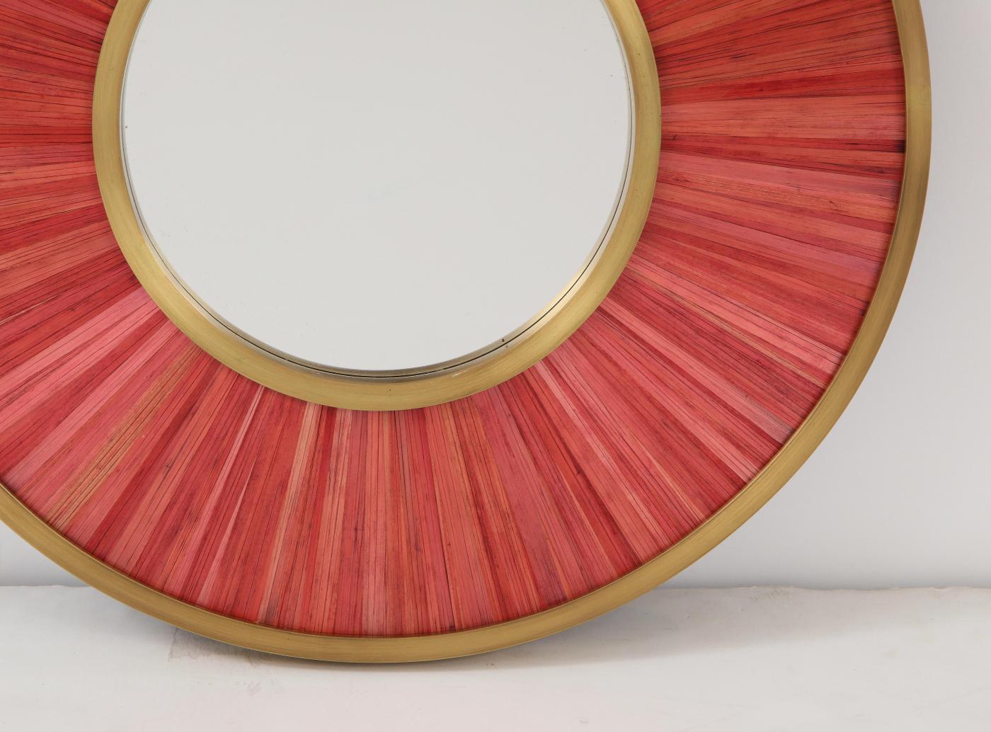 Modernist mirror. Executed in straw marquetry and solid brass frame.