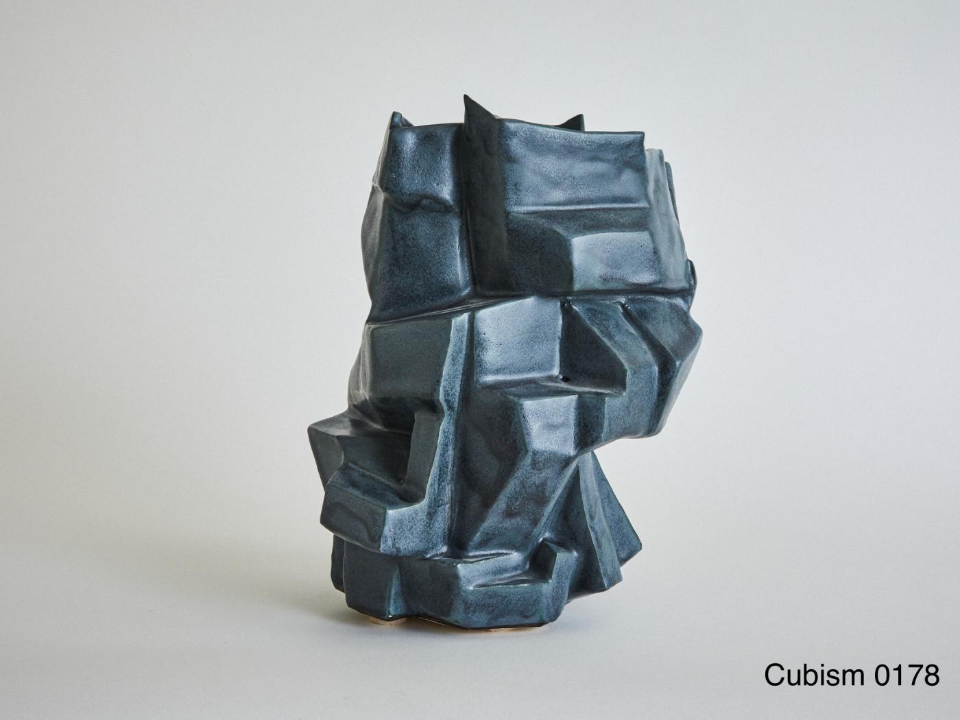 Wheel-thrown and manipulated cubist vessel in white stoneware.