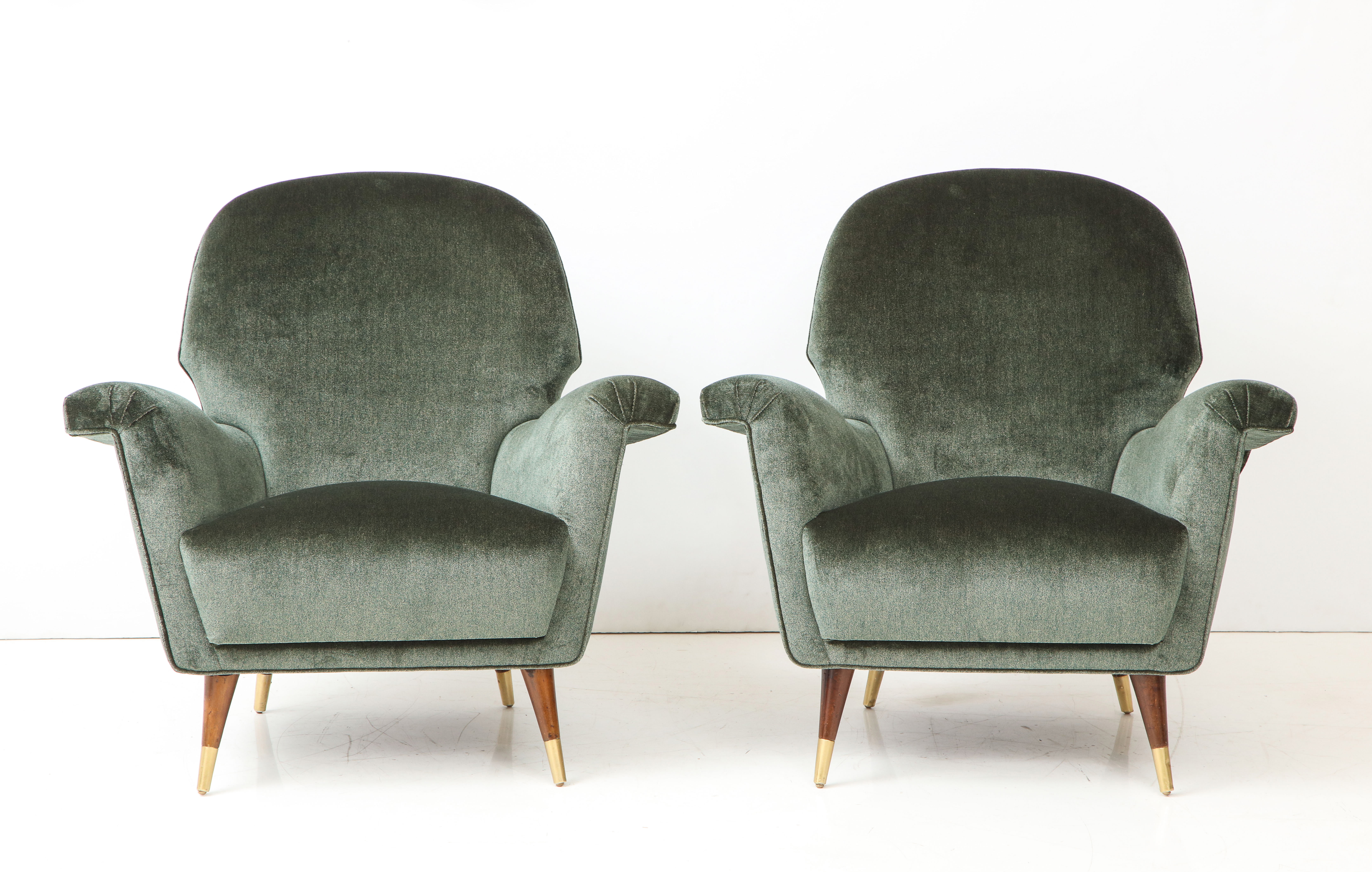 Pair of Mid Century Club Chairs. Walnut legs and brass details.