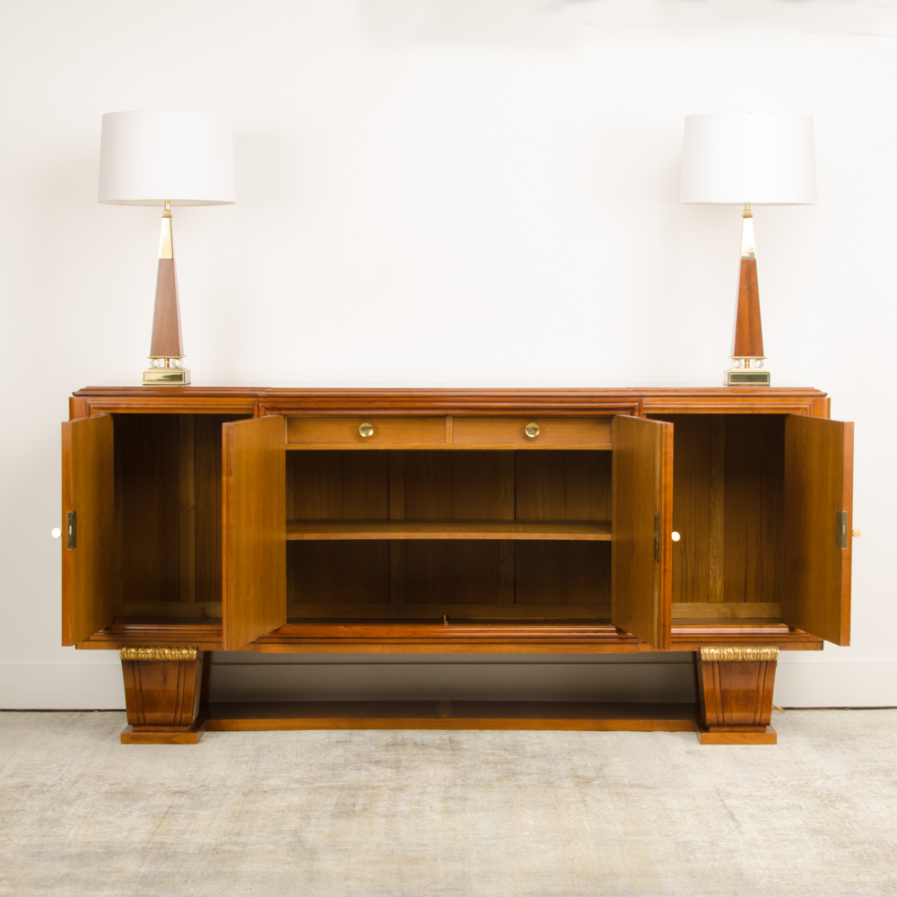 A fine French 1940's walnut veneer with gilded carved wood details sideboard.