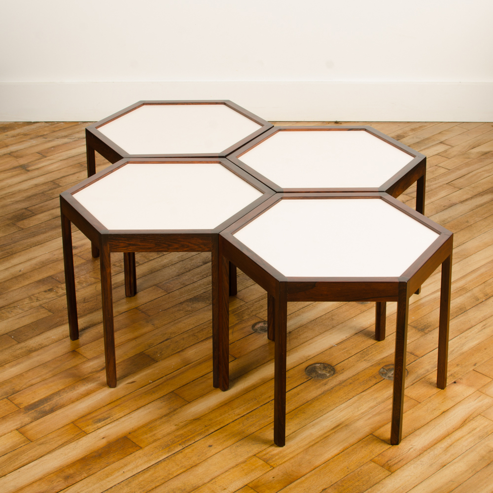 A set of four Danish side tables designed by Hans C Andersen. Hexagon shape with solid rosewood and white laminate top circa 1960. 