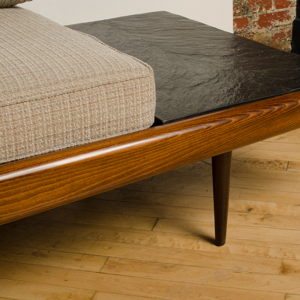  A Mid-Century Modern sofa in the manner of Adrian Pearsall. Walnut with slate inlay end tables. Circa 1950s.