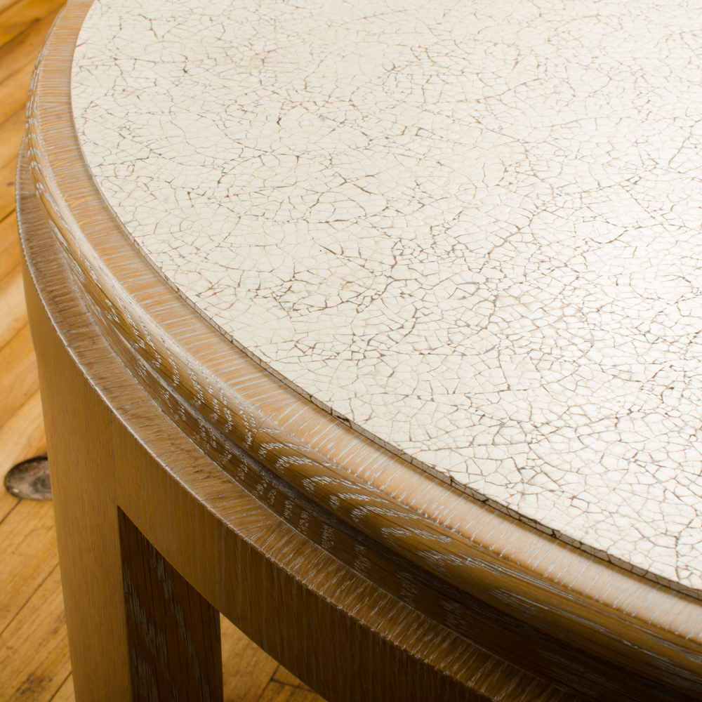 Modernist round cocktail table with eggshell fragment surface.